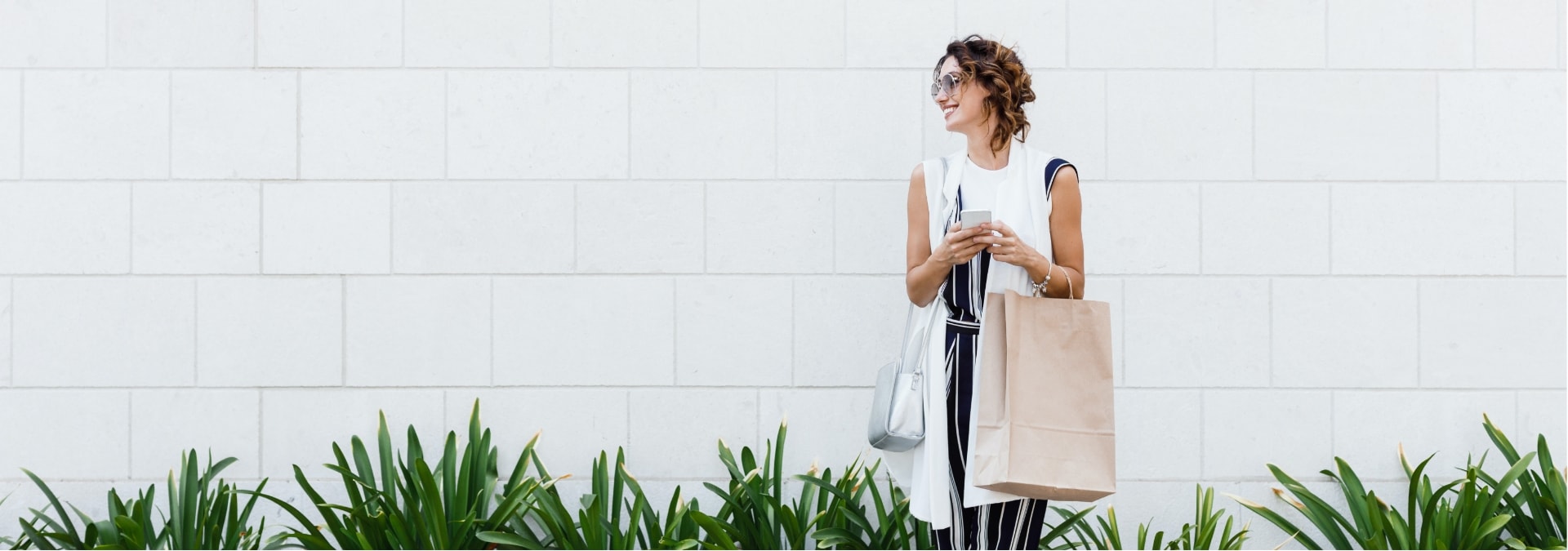 Girl waiting for cab with shopping bag