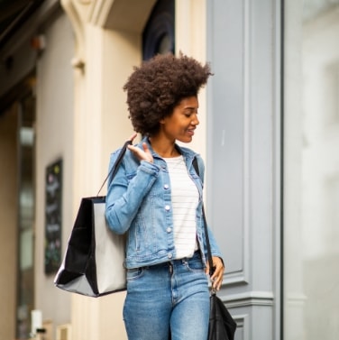 Girl in denim holding shopping bag