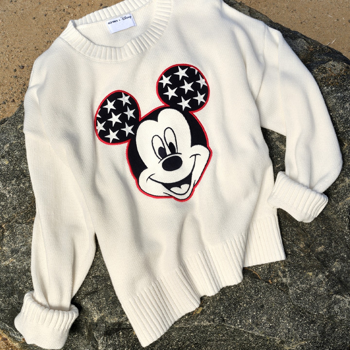 a white sweater with a patriotic Mickey Mouse on the front from Old Navy